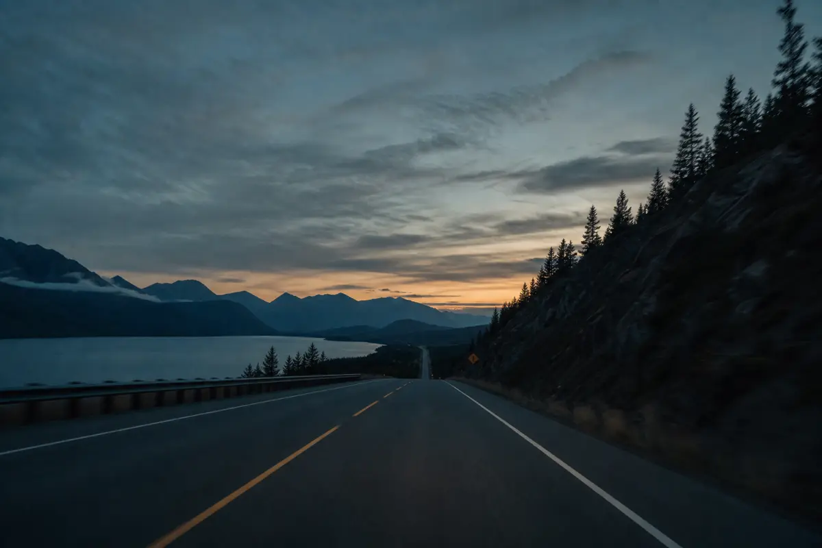 Open highway at dusk with distant mountains