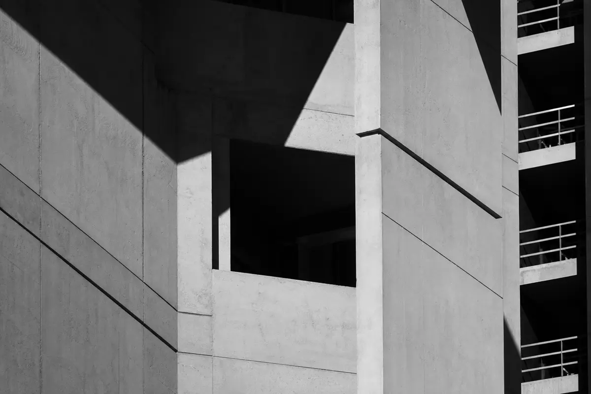 Geometric shadows cast across a modern building facade